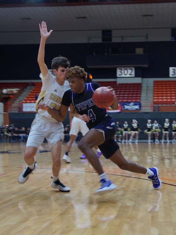 Junior Braijion Barnes charges the basket. He passed it to a teammate to make a shot, with a score of 28-23 Andover at half.