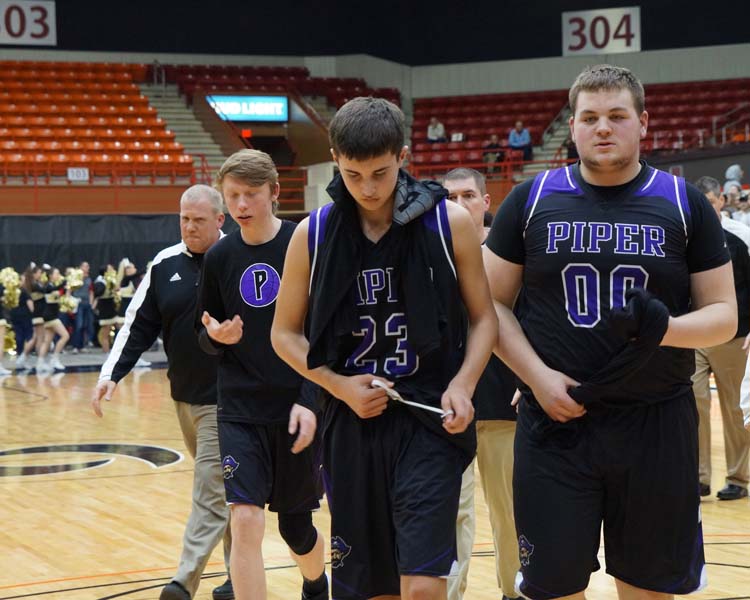 Sophomore Ty Shelly and Junior Cooper Beebe exit the court after the game March 8, leaving with a lost of 68-60.