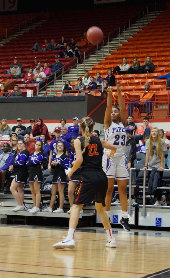 Junior Ryan Cobbins shoots a three in the second half against the Grizzles. The made shot stretched the Pirates comfortable lead.