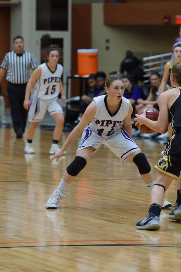 Sophomore Riley Porter stares down her opponent as she prepares to block a pass March 7.