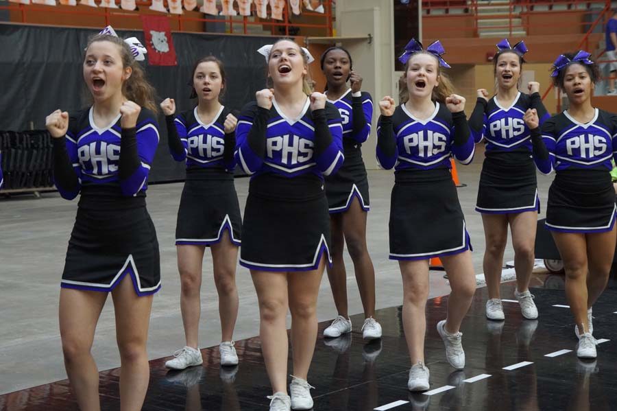 In the final quarter of the final game, the cheerleaders fire up the crowd for one last time. Seniors Sophia Frick and Grace Vogel join their teammates and sisters, Natalie Frick and Emma Vogel, on the court for the last time.