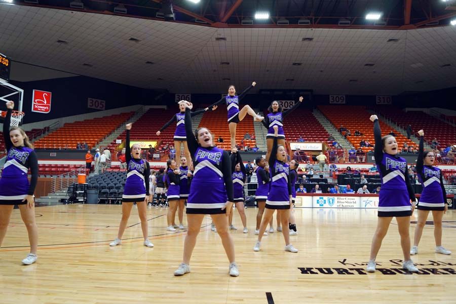 The Piper cheer team preform for the student section during halftime.