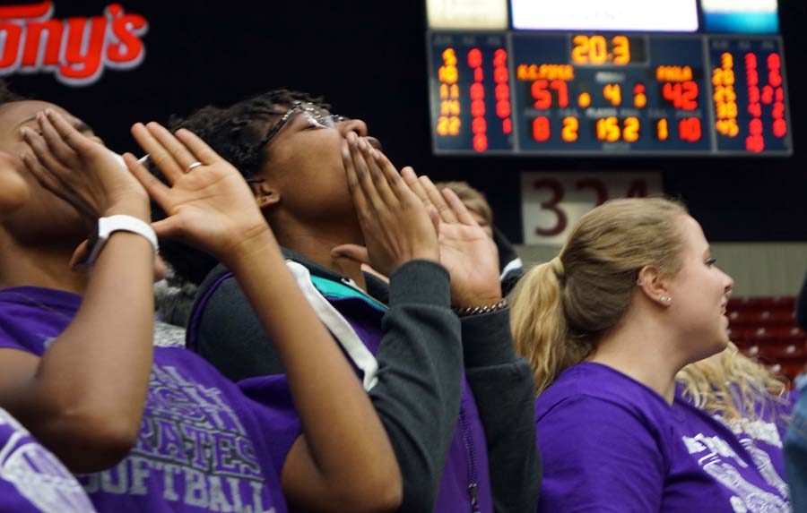Junior Jada Simmons and the student section cheer for the victory of the Lady Pirates in the game Wednesday night. 