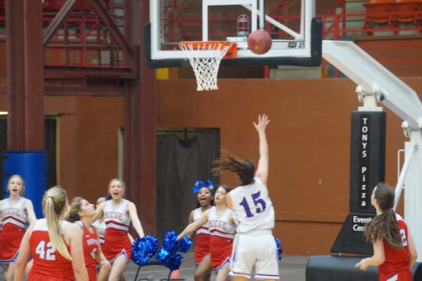 Sophomore Grace Banes puts the ball up for a layup and making it, scoring a point for the Pirates. 