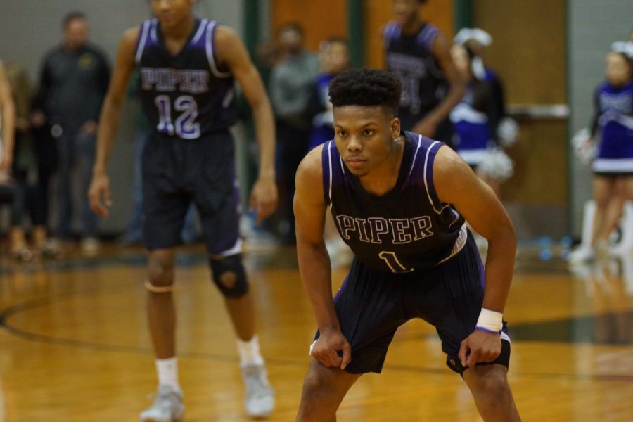 Senior Daviance Covington waits for Basehor to make their way down the court March 3