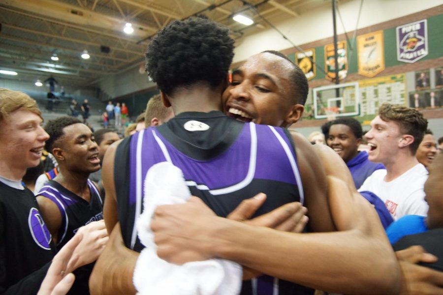 Freshman Tamar Bates and junior Brandan Jackson hug in excitement after winning the sub-state championship against Basehor March 3