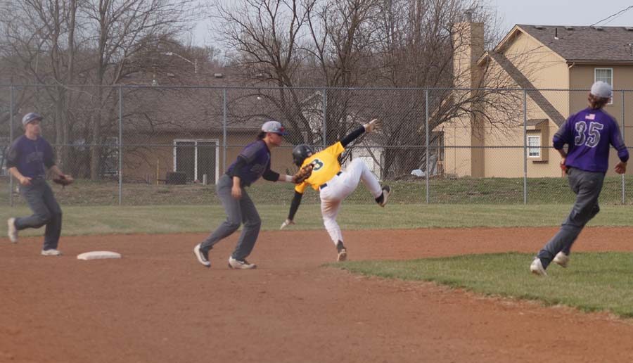 Junior Kimball Backus gets the base runner out after being in a pickle between second and third base.