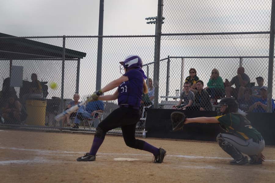 Freshman Kaylee Spencer hits the ball out to the outfield scoring two runs against Basehor.