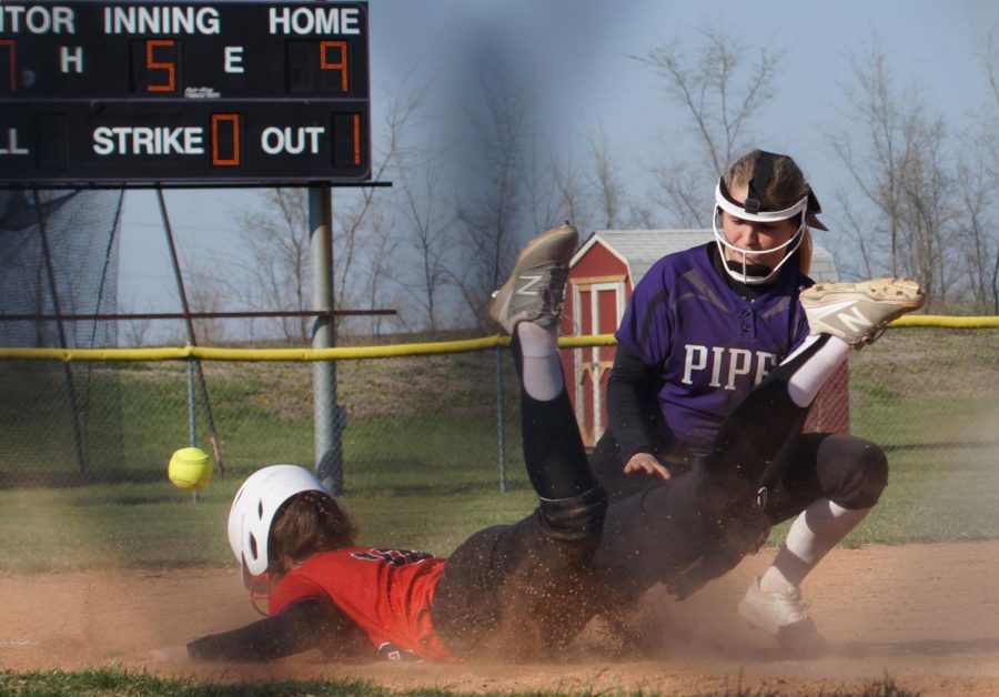 Junior Macey Nigh attempts to tag the runner out on third, yet loses the ball