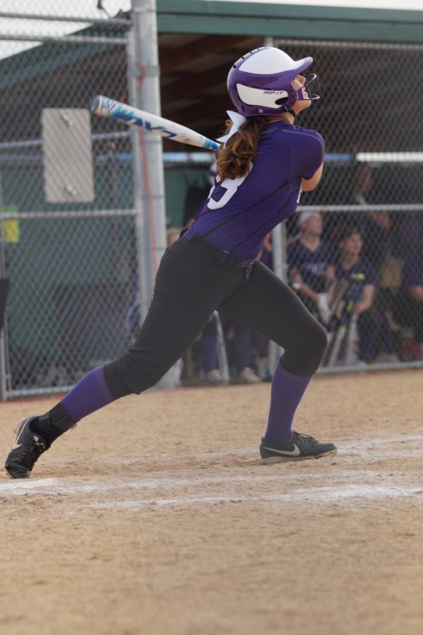 Senior Alexis Rymer watches her ball fly over the fence for her first of three homeruns that night.