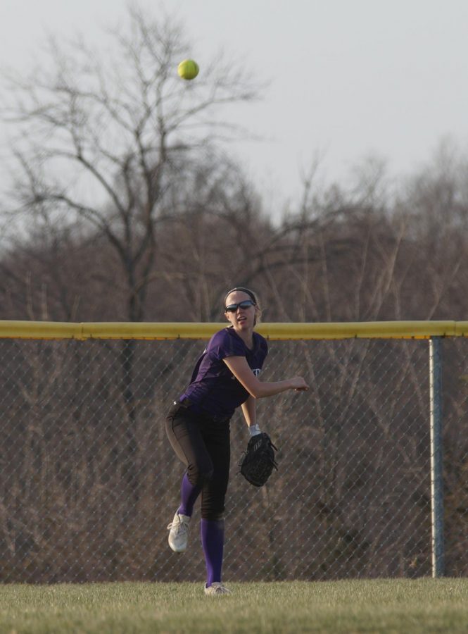 Senior Emma Golden throws the ball in from the outfield in attempt to get the runner out on second base.