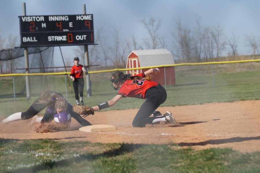 Junior Macey Nigh secures 3rd base while losing her helmet against the Cyclones, April 17