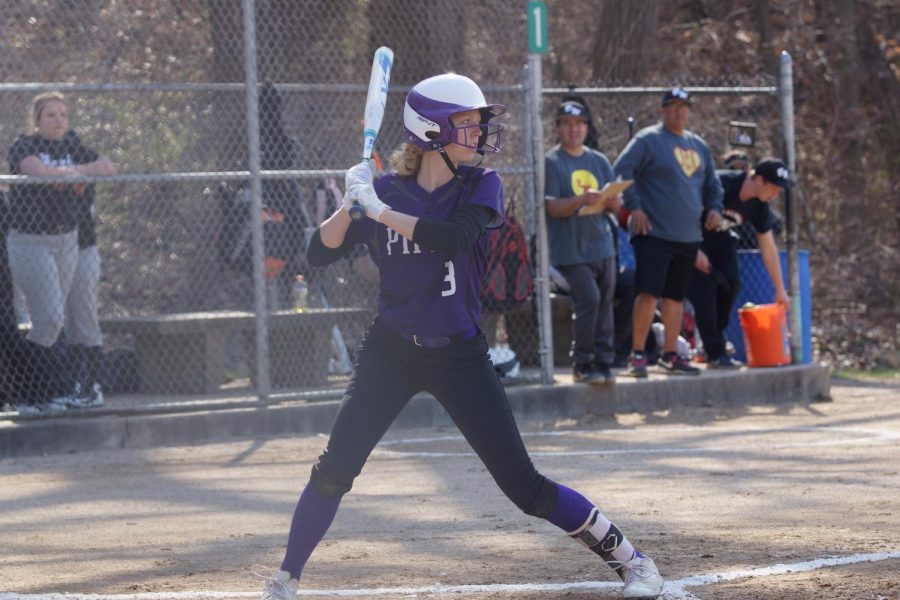 Senior Emma Golden is up to bat, digging her foot into the plate as she takes a swing.