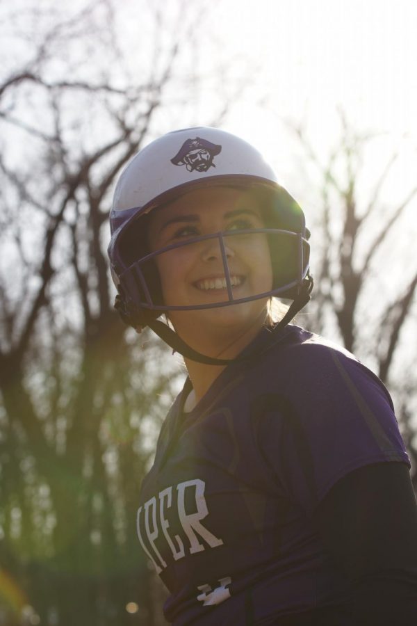 Sophomore Lauren Pappert smiles back at her team before she goes up to hit on April 5