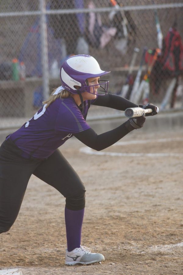 Sophomore Emma Martin takes her stance to bunt on April 5
