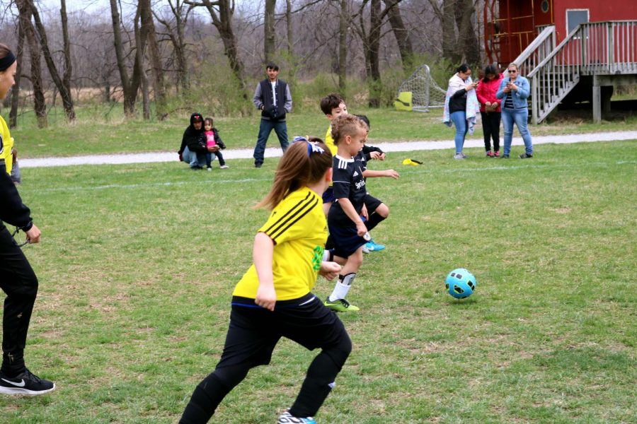Soccer Player, Goerge is leading the ball to the opponents goal.