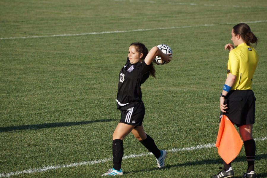 Junior Alyia Cantrell throws the ball back to the field after Balwins players kicked it out.