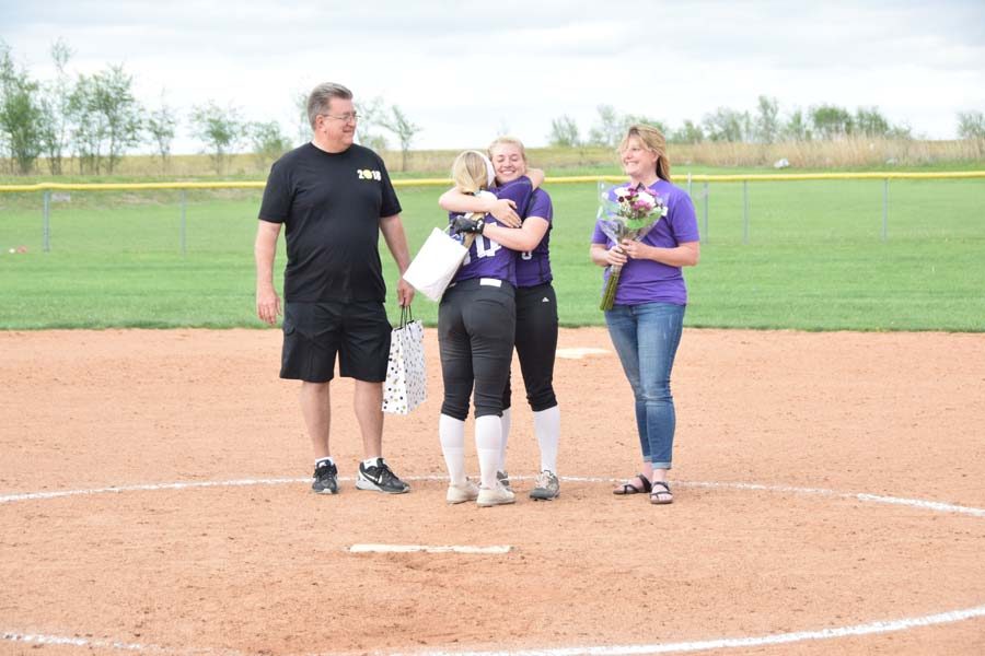 Senior Makayla Stack and junior Macey Nigh embrace each other as teammates for her last season of softball. 