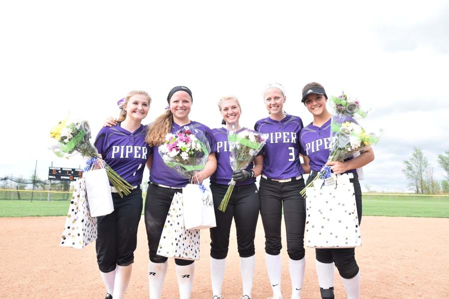 The 2018 softball seniors stand together at the end of their season.