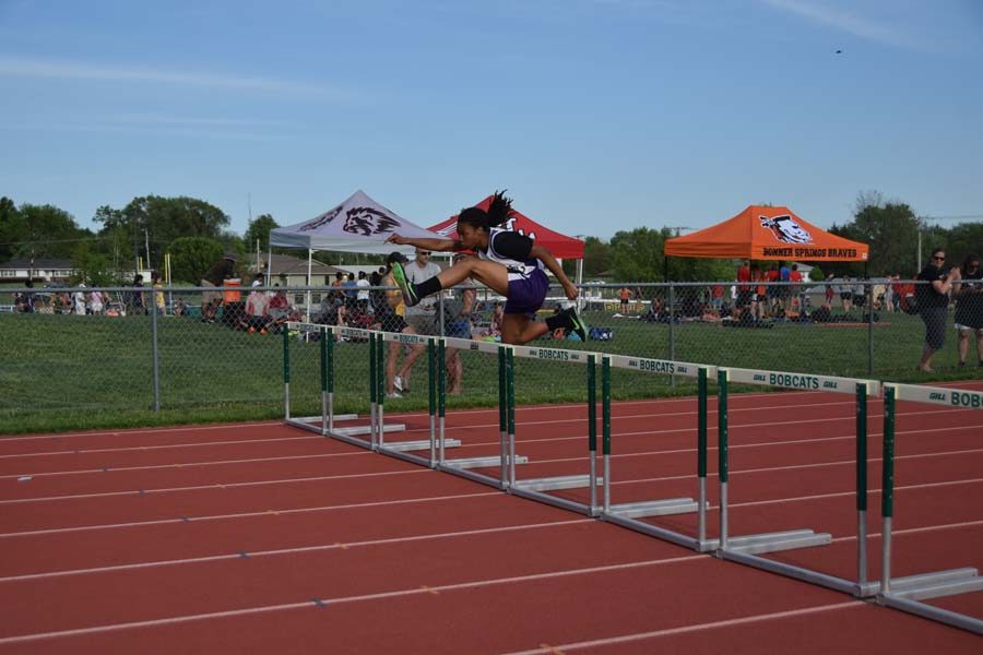 Freshman Camaro Scott hurdles in 300 meter race. 