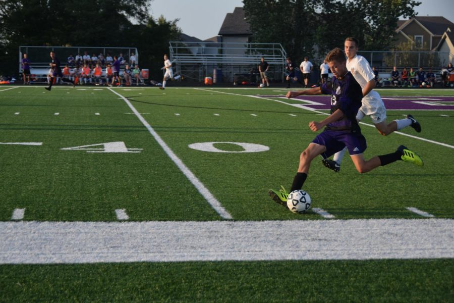 Junior Owen Roellchen passes a ball to a teammate down the field. 