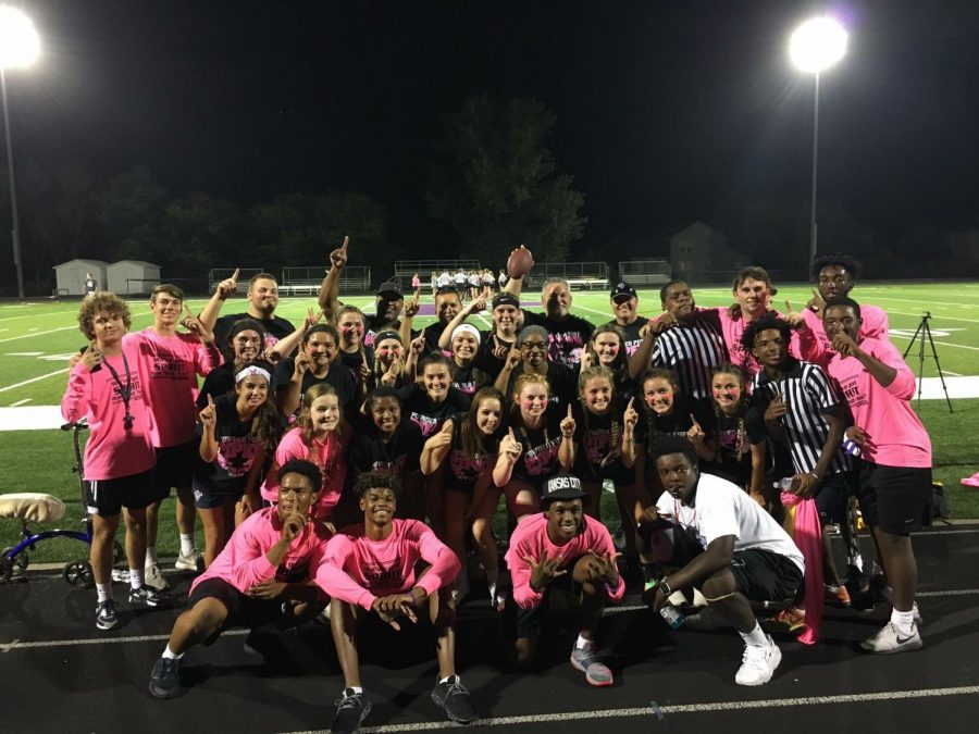 The senior PowderPuff players, referees and dancers gather for a photo to carry on a tradition. 