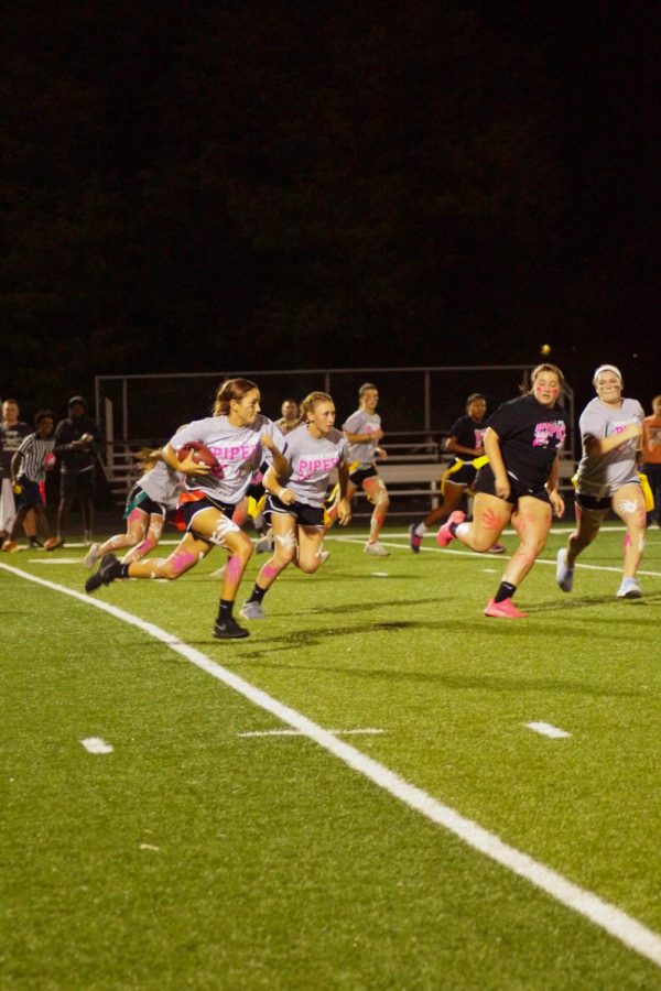 Sophomore Evelyn Vasquez runs the ball while junior Riley Porter defends her. 