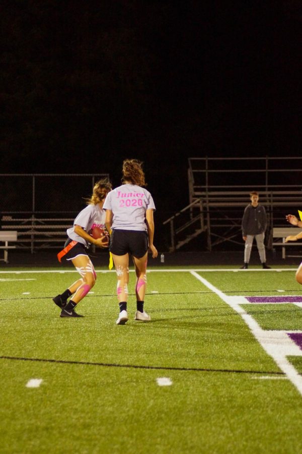 Evelyn attempts to get past the senior-freshmen defensive line after senior Grace banes hands her the ball. 