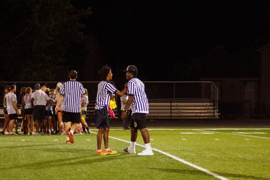 Senior referees Devon Marshall and Brandon Walker discuss the call after a flag is thrown.