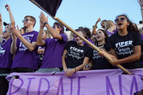 Senior girls celebrate at the football game against Eudora on Sept. 13. The girls decided to start the campaign to show more school spirit before they graduate.