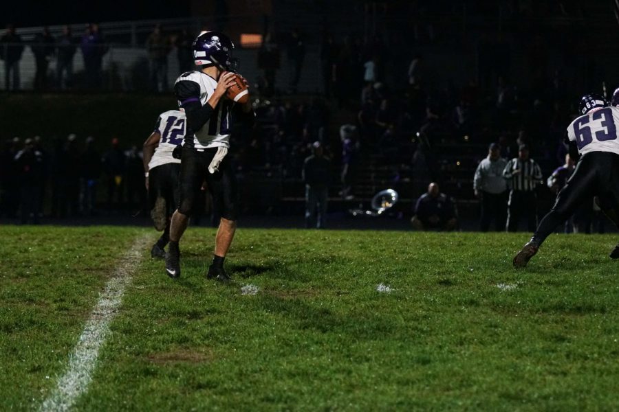 Quarterback Dalton White looks for an open player to throw the ball to in hopes to get closer to the end zone.