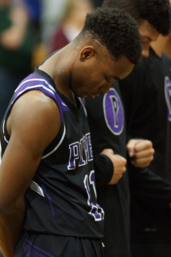 Senior Trey Bates bows his head during the national anthem during last year's sub-state game at Basehor-Linwood