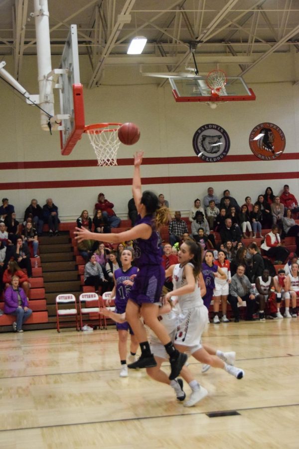 Junior Alison Vigil scores a fast break layup.