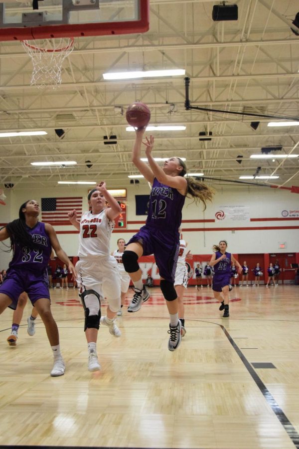 Junior Riley Porter steals the ball from the Ottawa Cyclones and makes a layup. 