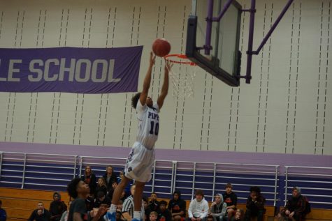 Sophomore Jami Tyson jumps for a layup scoring a point for the Pirates.