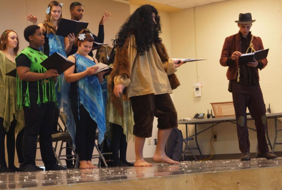 	The protagonist“Wily” played by Junior Ty Shelly, exchanges words with the antagonist in the play “The Hairy Man,” played by Sophmore Kyron Fergus. Part of the chorus, Sophomore Gwen Gambrill,  Junior Kenny Brown, Freshman Alora Jones, Freshman Malachi Watson, Junior Jaqualyn Wheeland, and  Freshman Andrea Alvarez, add dramatic affect to the exchange between the protagonist, and the antagonist.