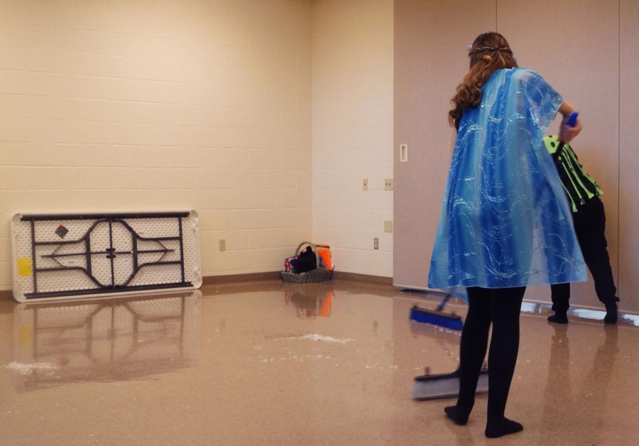 Sophomore Gwen Gambrill helps clean up at the Elementary School after a successful production of Wily, and the Hairy Man.