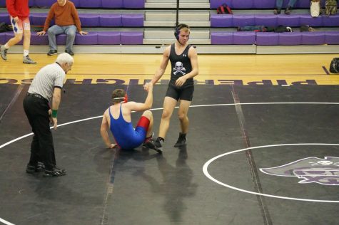 Sophomore Branden Martin helping his opponent up after a match.