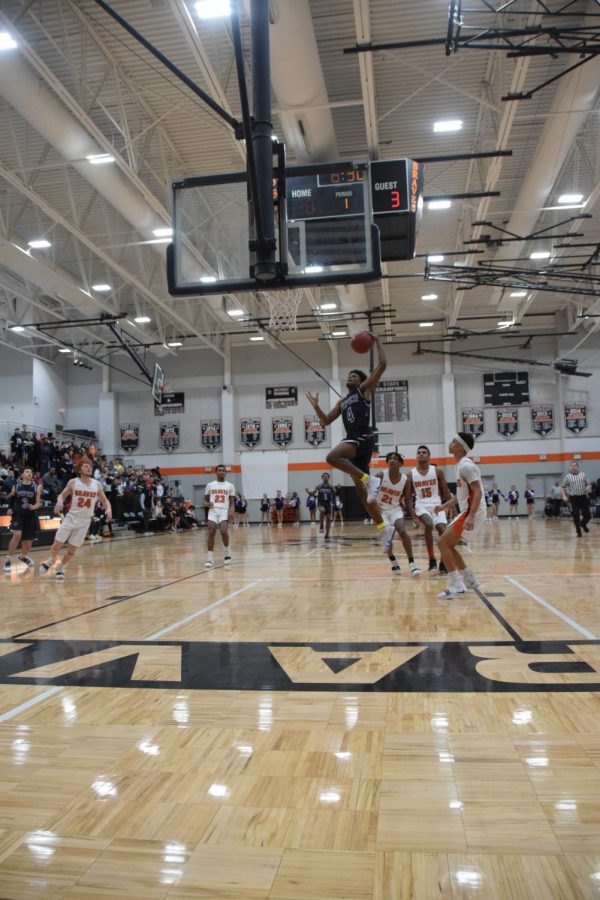 Senior Braijon Barnes dunks in the first quarter of the game. 