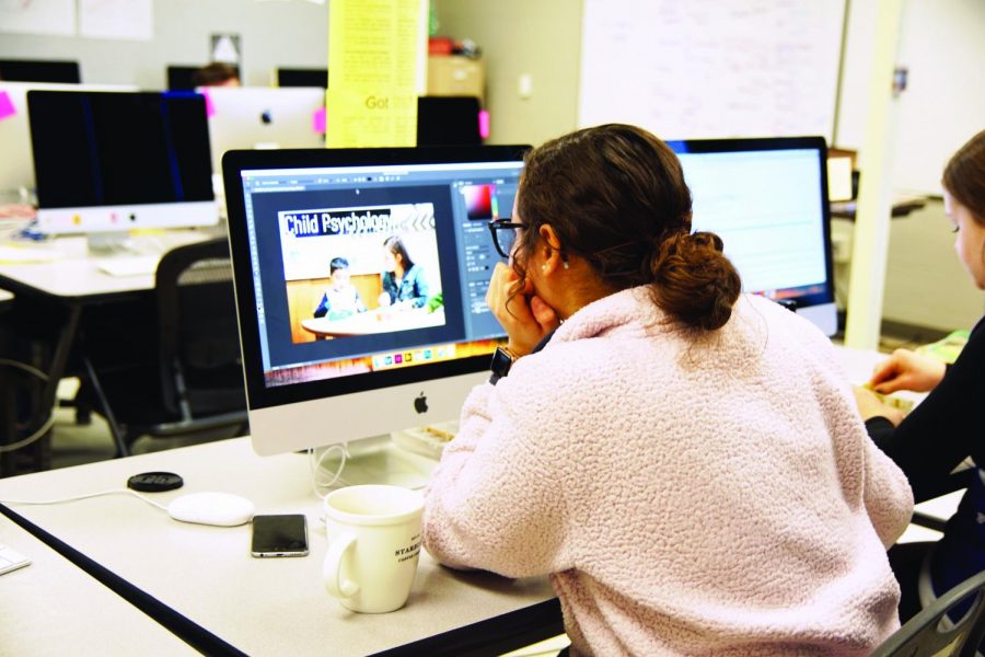 Senior Marisa Sanchez works to create her senior poster about her project on child psychology Dec. 11.