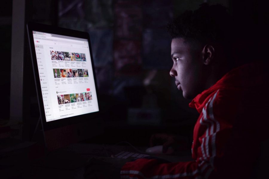 Sophomore Christien Johnson searches for a video to watch during his class. During downtime in his photojournalism class Johnson enjoys watching various videos including sports, humorous videos and streaming services. 