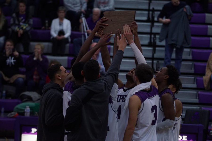 The Pirate boys lift the Sub-State plaque in celebration after beating Field Kindley High School.