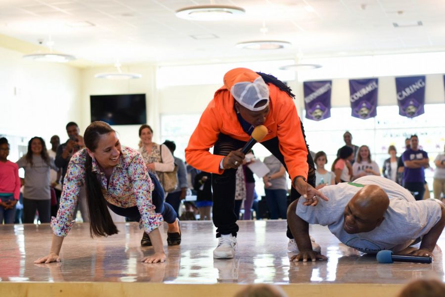 Representative Sharice  Davids and Head of Inclusion Council Morris Letcher compete in a push up contest upon request. Davids won while laughing at Letcher.  
