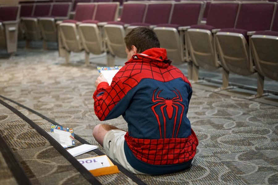 Senior Tyler Hoover-Trusskey looks through his eighth grade time capsule. Time capsules were created by Principal John Nguyen, their former english teacher.