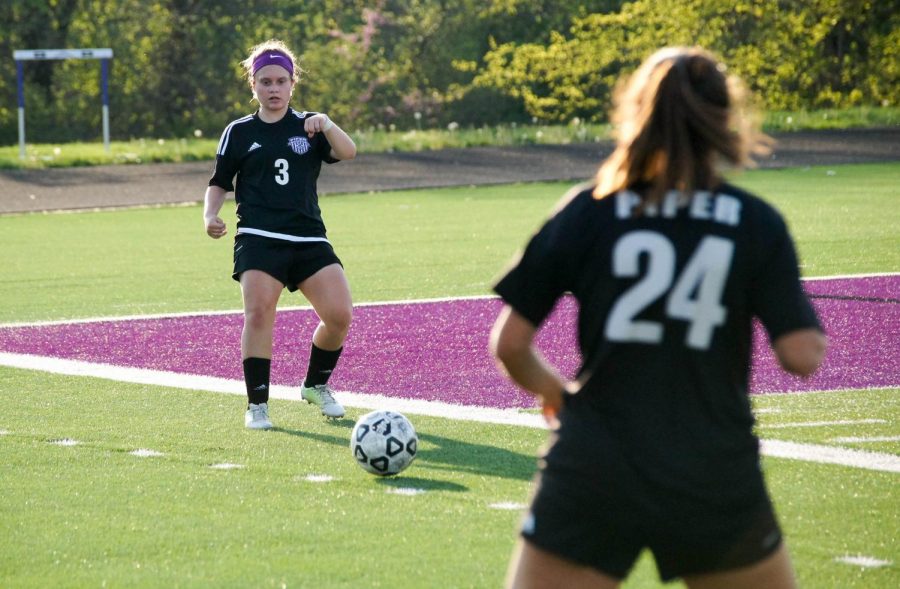 Junior Emily Brandt passes the ball to a senior teammate Josie Barbosa during a game against Bishop Miege.