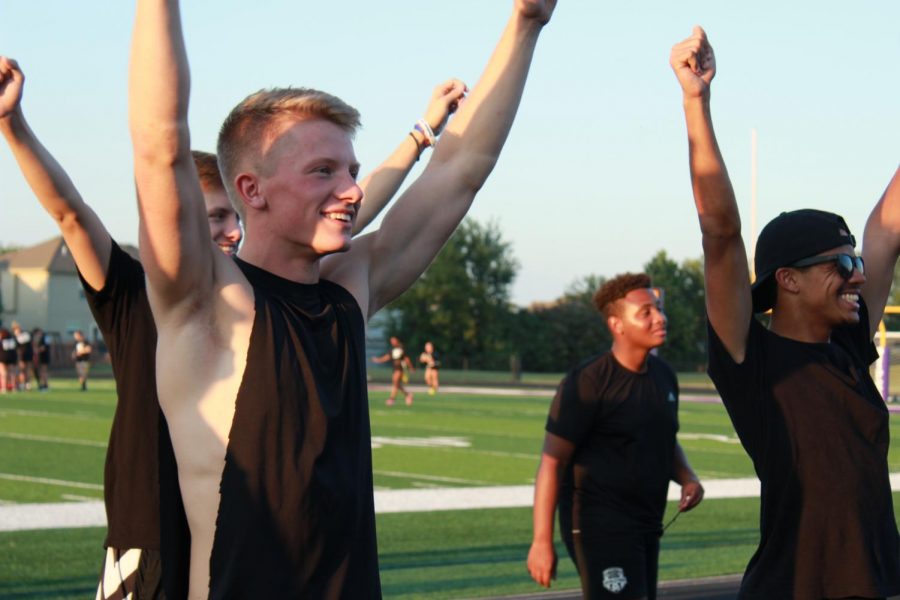 Senior boys Timothy Lemanske and David Holmes cheer on the girls at the Powderpuff game. Attending  the game earned points for Class Cup.