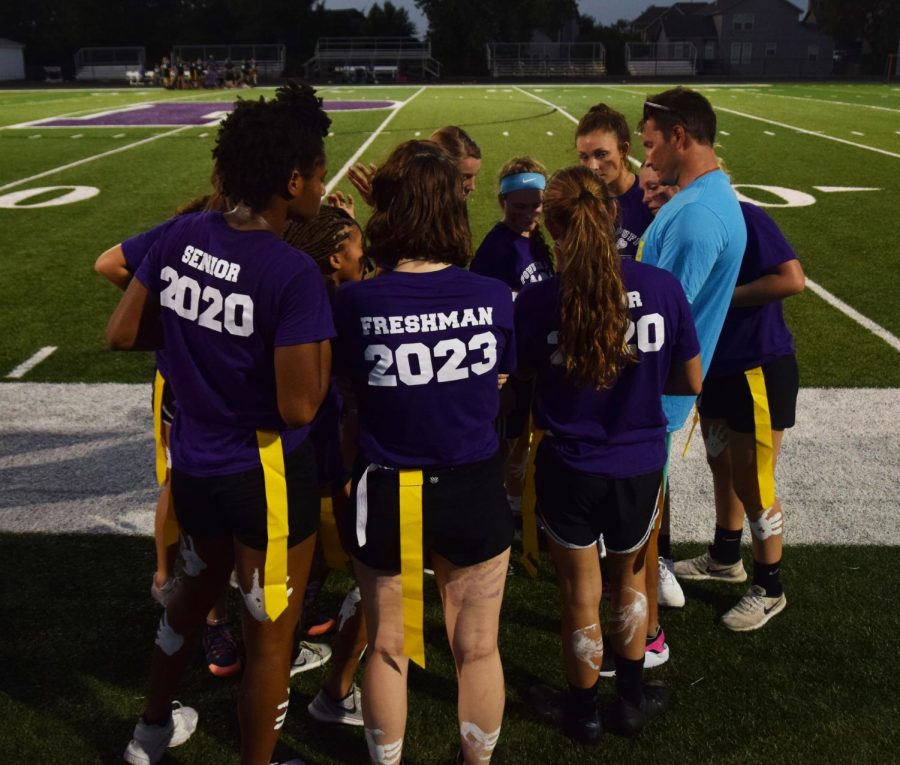 The senior-freshman team huddle around coach Bryan Shelley to discuss their game plan after half time. 