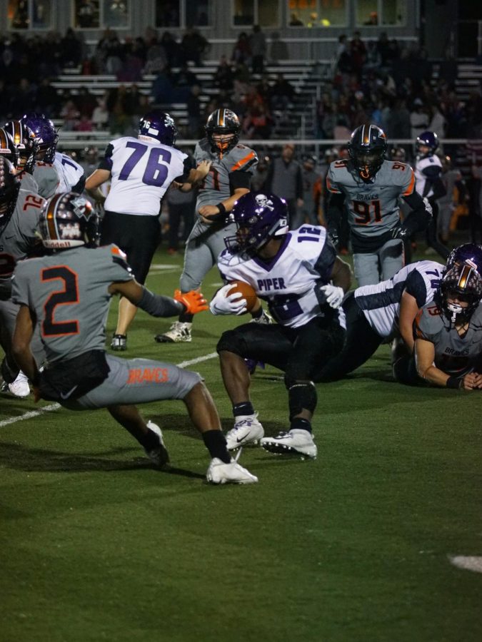 Junior LaJames White avoids Braves' defense. He had a gain of seven yards.