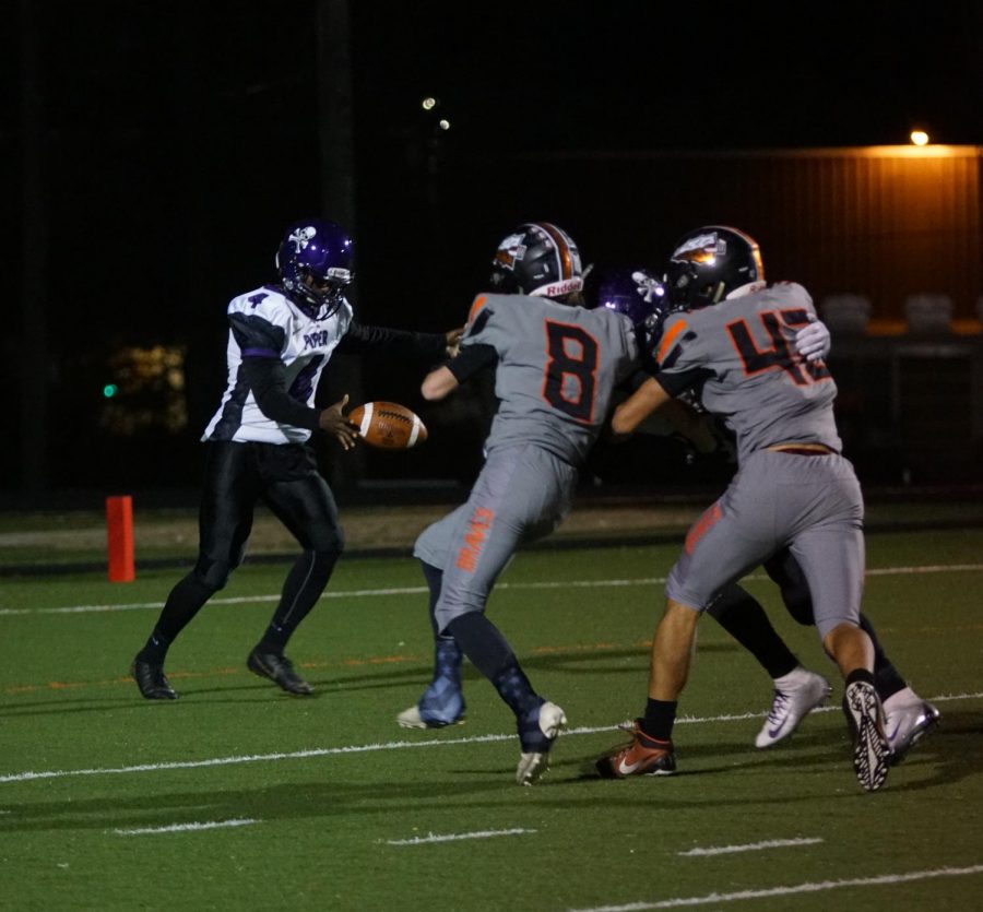 Senior Miles Lockridge  punts after the Pirates fail to reach a first down