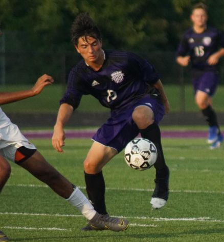 Junior Kyron Fergus dribbles through defenders against Shawnee Mission North on September 3. The Pirates went on to lose the game.